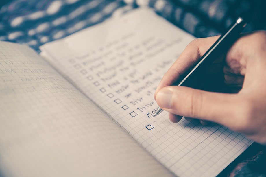 Stock image of someone writing to-do's in a notepad